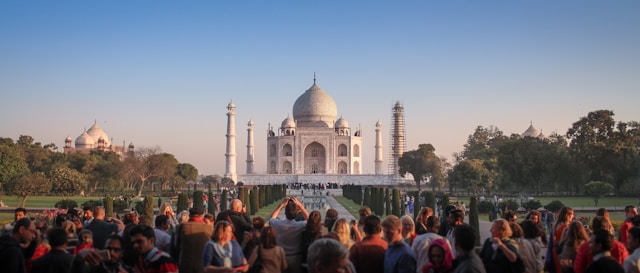 Visitors admiring the Taj Mahal at sunset