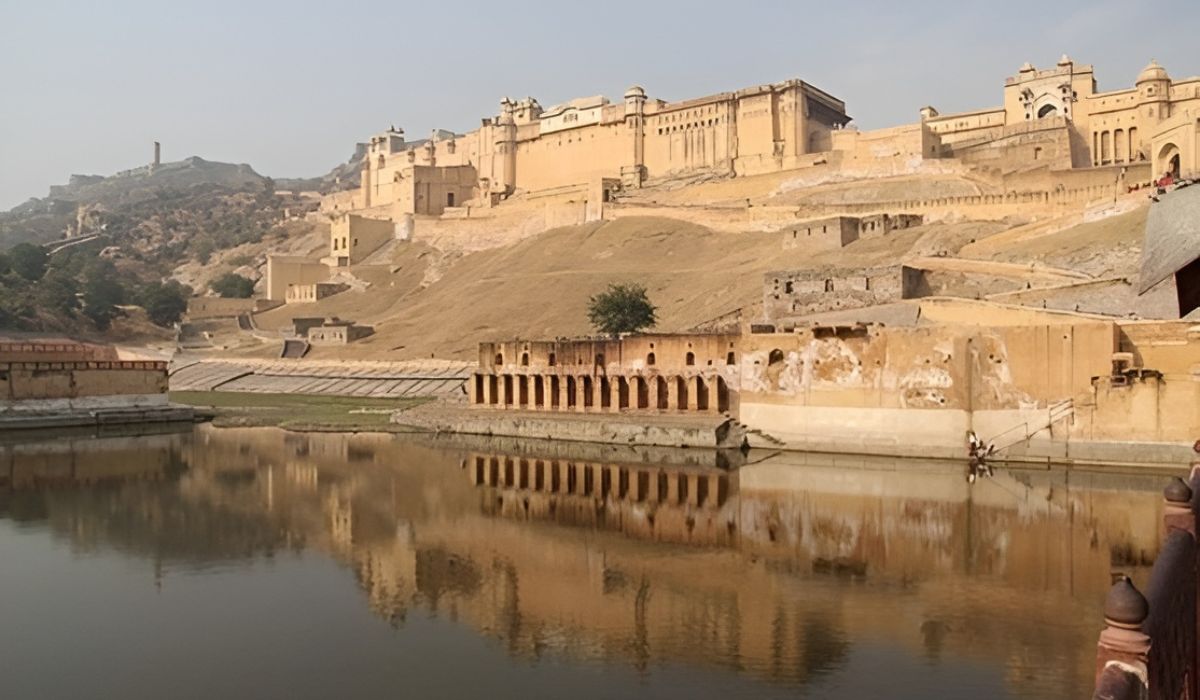 Amber Fort overlooking Maota Lake with reflections in the water, a major attraction on the Golden Triangle India Tour.